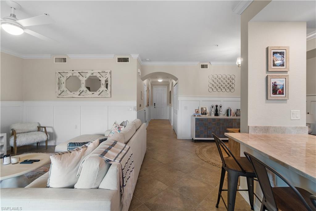 9834 Giaveno Circle, Unit 1726 Naples, FL 34113 - Photo 5 of 20 a living room with furniture and wooden floor