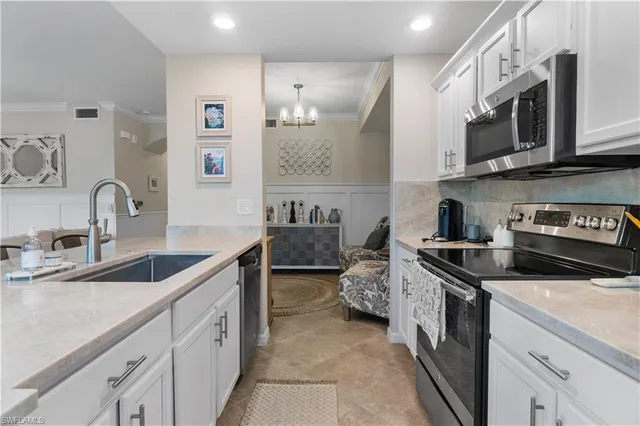a kitchen with stainless steel appliances granite countertop a sink and cabinets