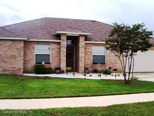 2408 Mallory Hills Road Jacksonville, FL 32221 - Photo 1 of 1 a front view of a house with a yard and garage