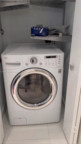 a kitchen with white cabinets stainless steel appliances and sink