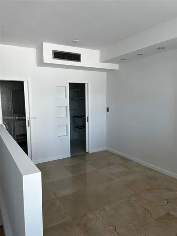 a bedroom with a bed and a view of bathroom