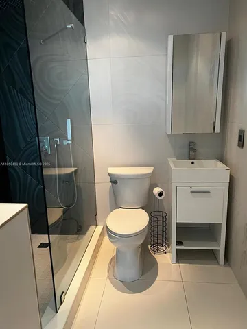 a bathroom with a shower and a toilet