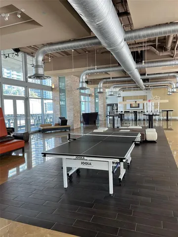 a backyard of a house with wooden floor and outdoor seating