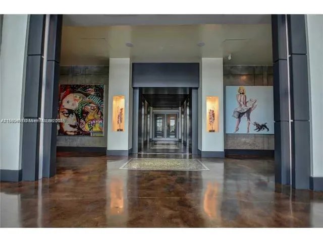 a view of a hallway with wooden floor and a fireplace