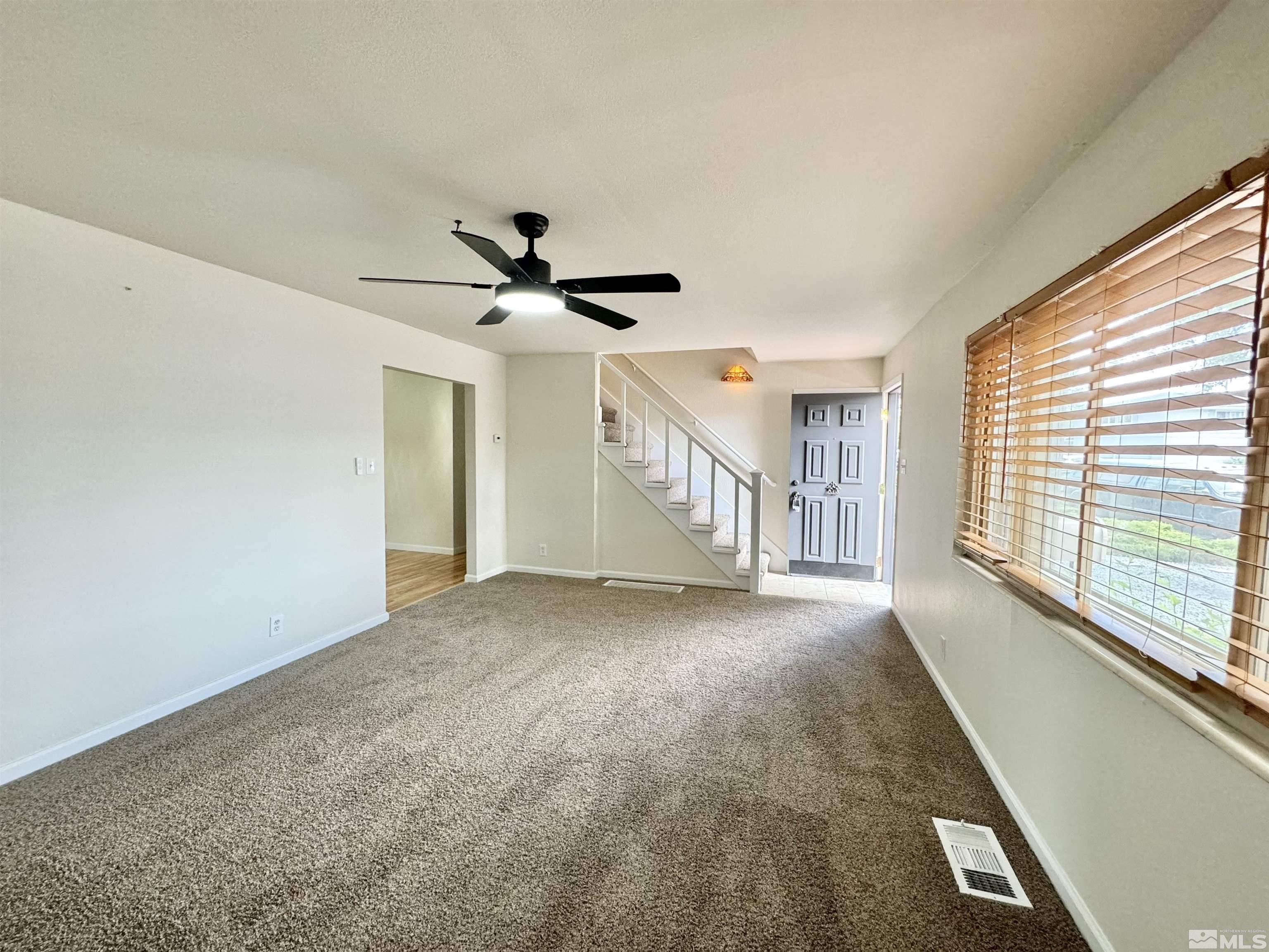 4640 Aster Drive Reno, NV 89502 - Photo 11 of 22 a view of a livingroom with a ceiling fan and window