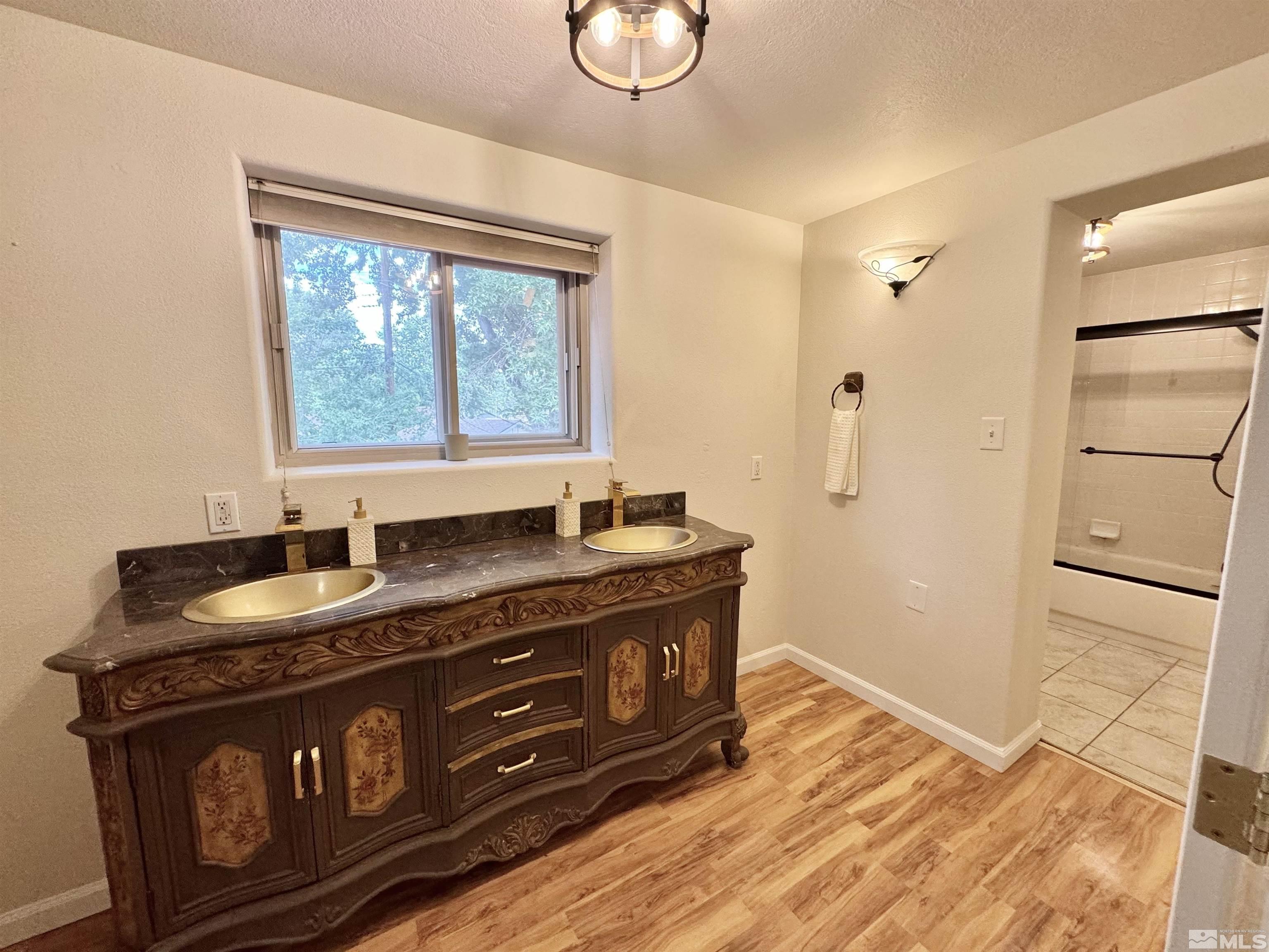 4640 Aster Drive Reno, NV 89502 - Photo 13 of 22 a bathroom with a granite countertop sink toilet and mirror
