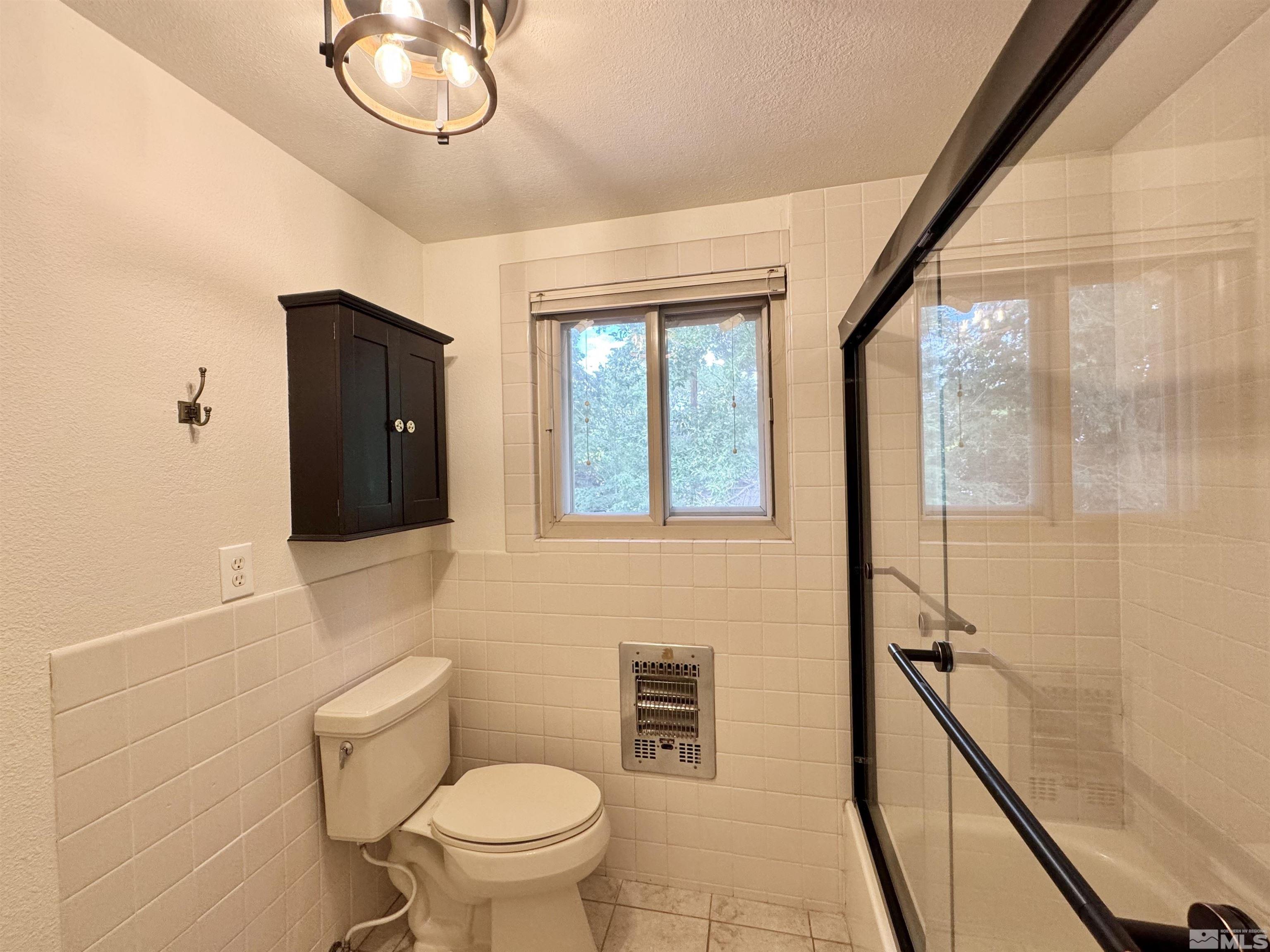 4640 Aster Drive Reno, NV 89502 - Photo 14 of 22 a bathroom with a toilet a sink and a shower