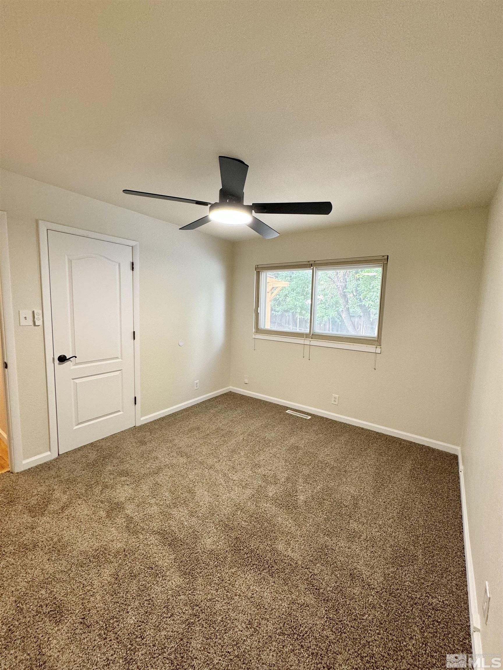 4640 Aster Drive Reno, NV 89502 - Photo 18 of 22 an empty room with a empty space and windows
