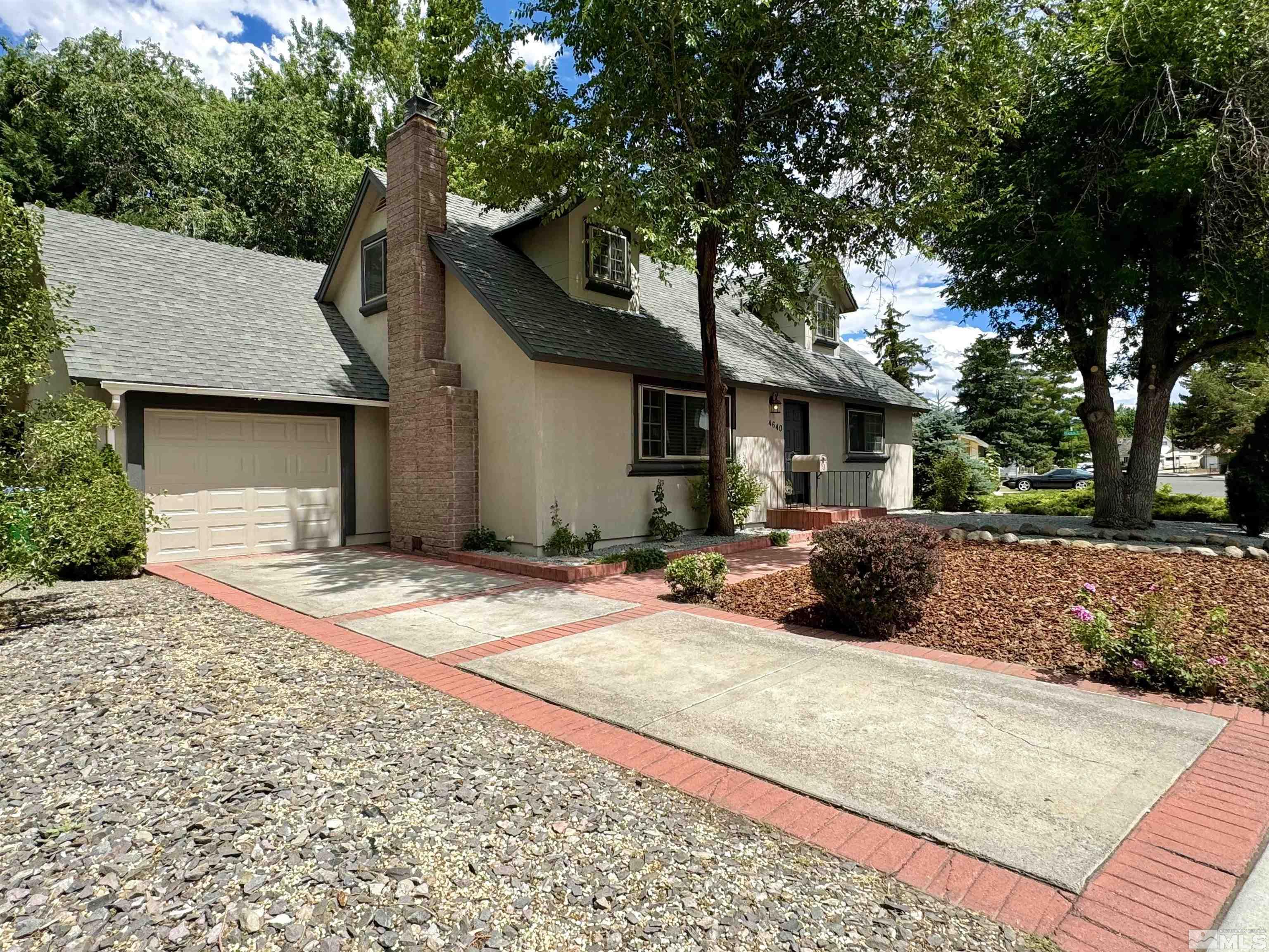 4640 Aster Drive Reno, NV 89502 - Photo 3 of 22 a view of a house with backyard and a tree