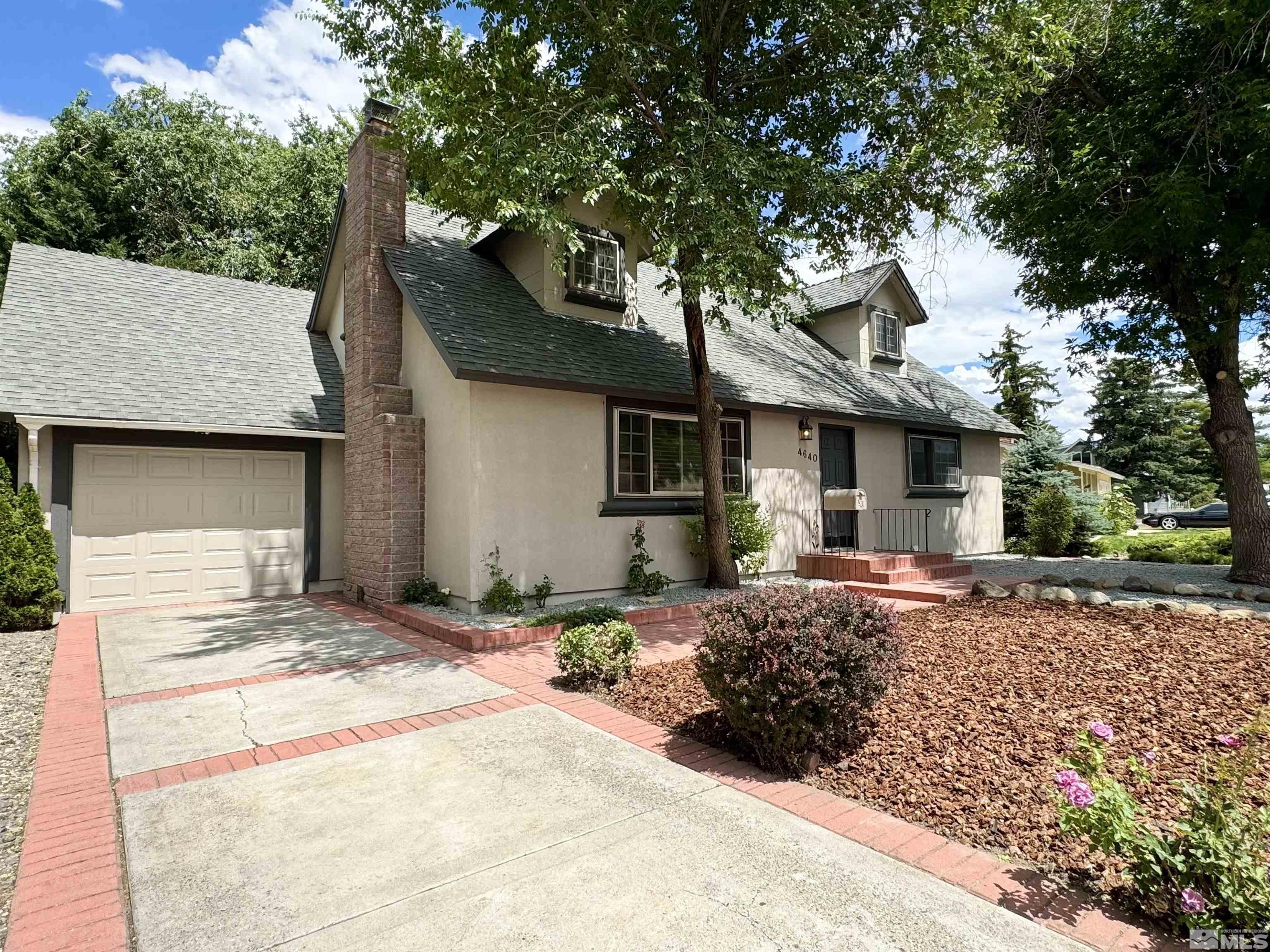 4640 Aster Drive Reno, NV 89502 - Photo 4 of 22 a front view of a house with a garden