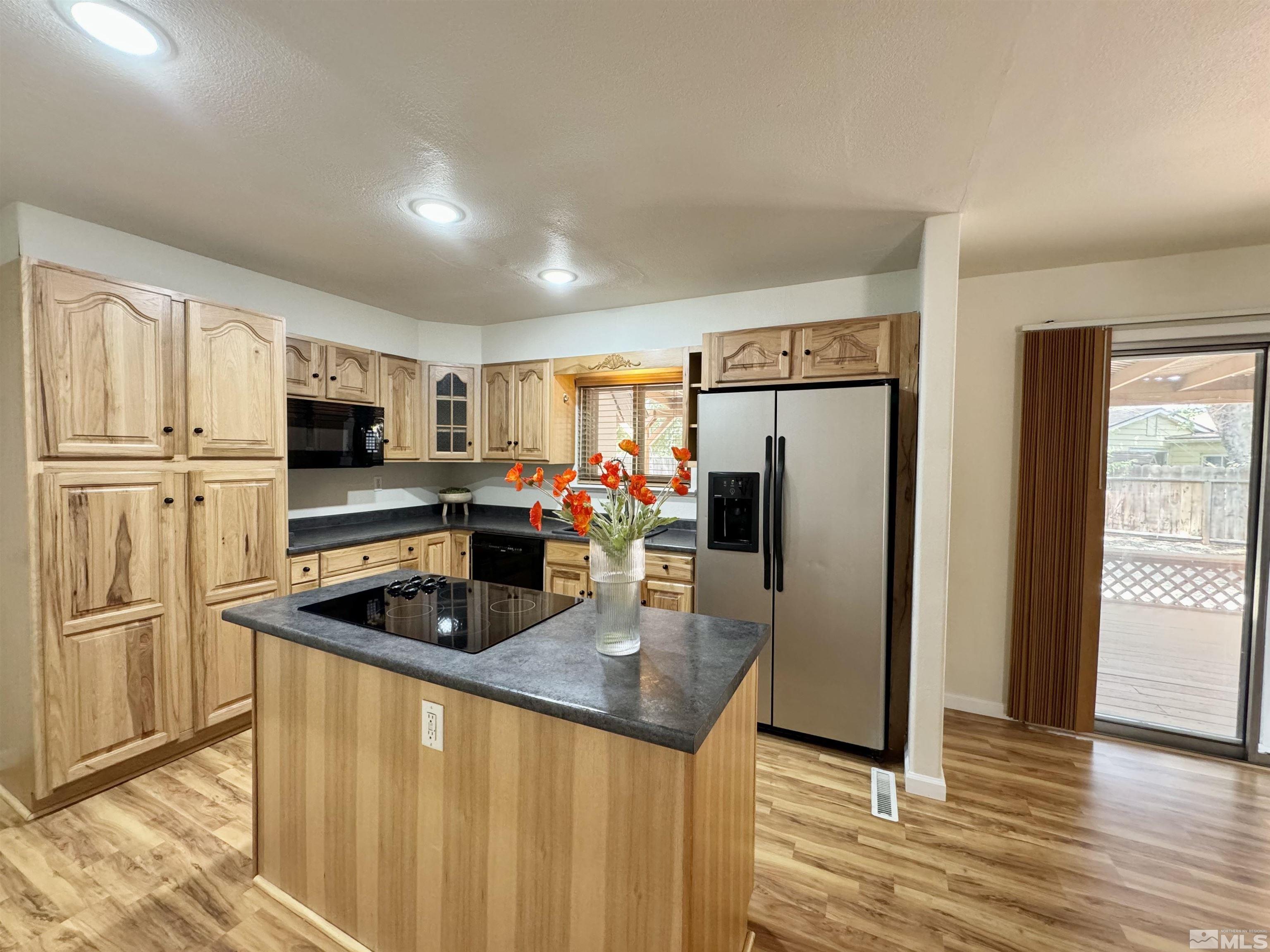 4640 Aster Drive Reno, NV 89502 - Photo 6 of 22 a kitchen with stainless steel appliances granite countertop a refrigerator stove microwave and sink