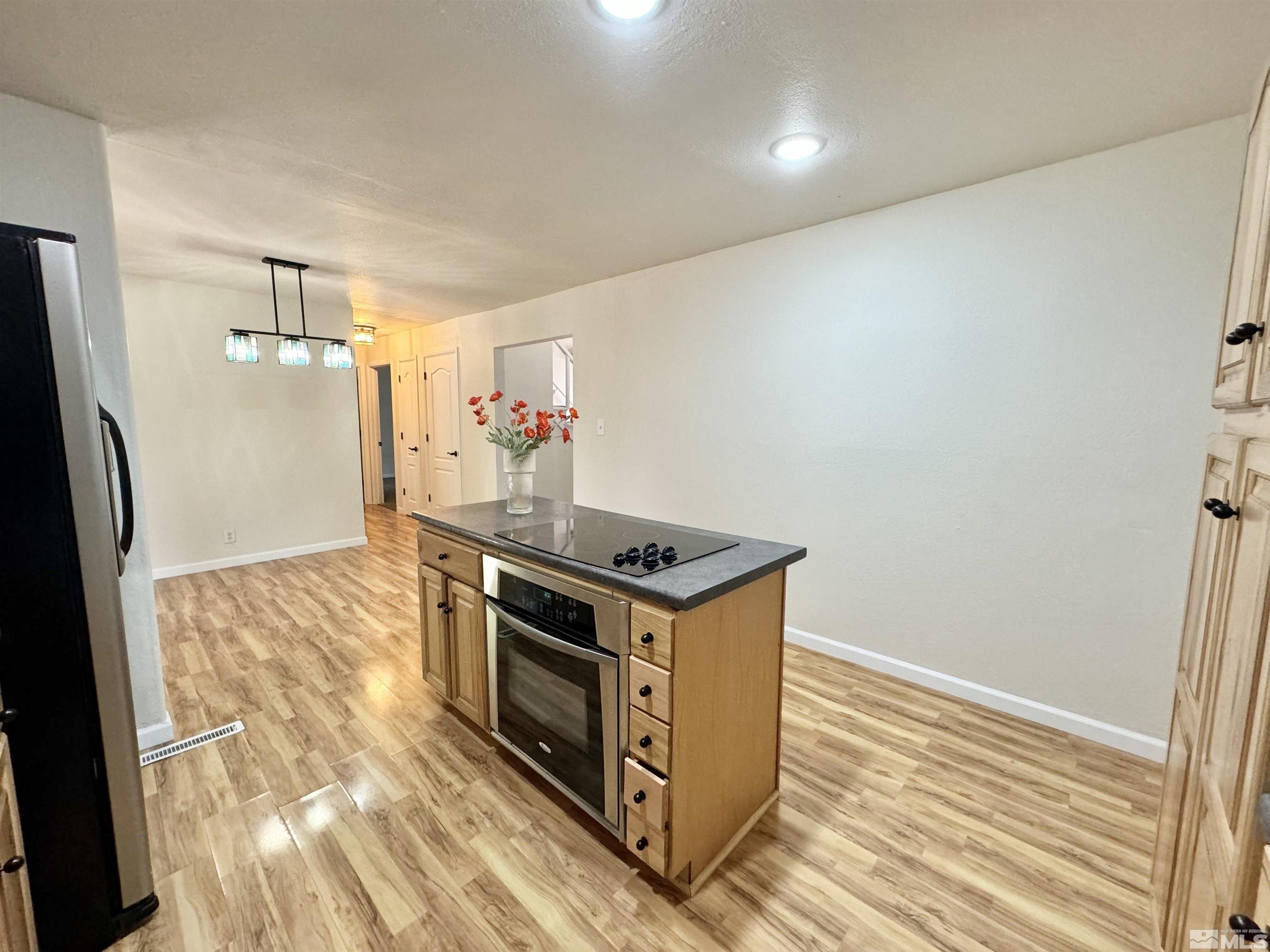 4640 Aster Drive Reno, NV 89502 - Photo 7 of 22 a kitchen with a stove and a refrigerator