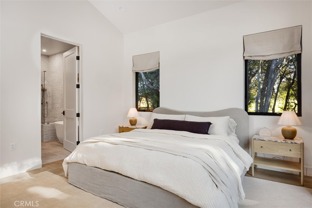 5260 Windmill Way San Luis Obispo, CA 93401 - Photo 16 of 35 a bedroom with a large bed and a painting on the wall