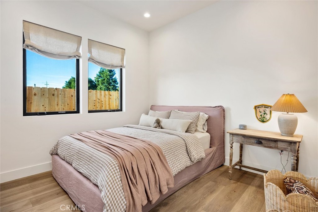 5260 Windmill Way San Luis Obispo, CA 93401 - Photo 22 of 35 a bedroom with a bed a window and painting on the wall