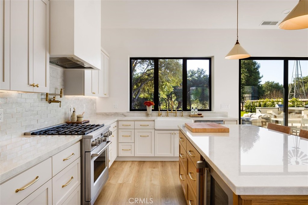 5260 Windmill Way San Luis Obispo, CA 93401 - Photo 8 of 35 a kitchen with stainless steel appliances granite countertop a sink a stove and a wooden floors