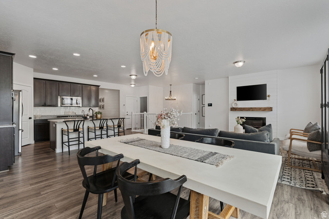 1002 South Yarrow Drive Mapleton, UT 84664 - Photo 11 of 39 Spacious open-concept living area featuring wood-finish flooring, a contemporary beaded chandelier, and recessed lighting