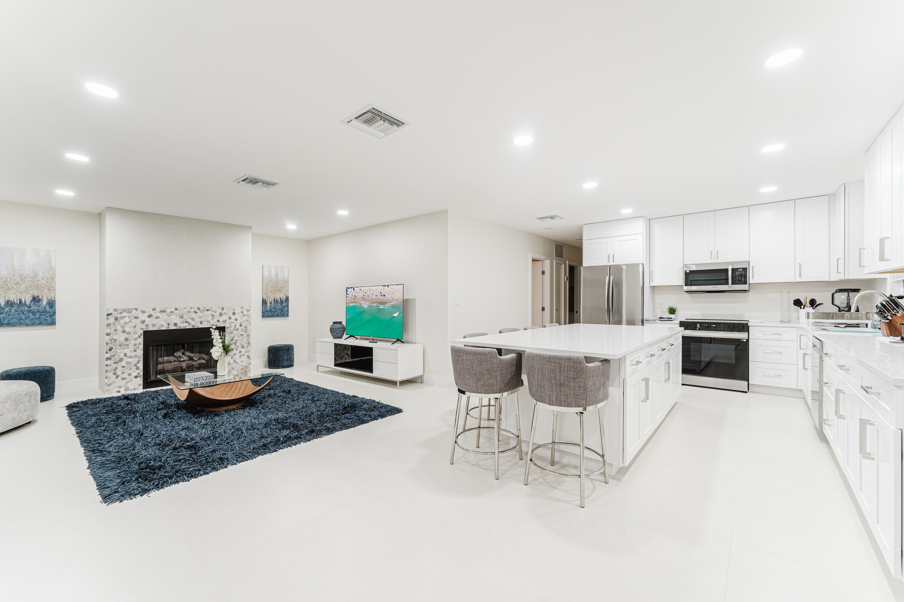 3199 Northeast 6th Drive Boca Raton, FL 33431 - Photo 1 of 49 a kitchen with microwave a stove and chairs