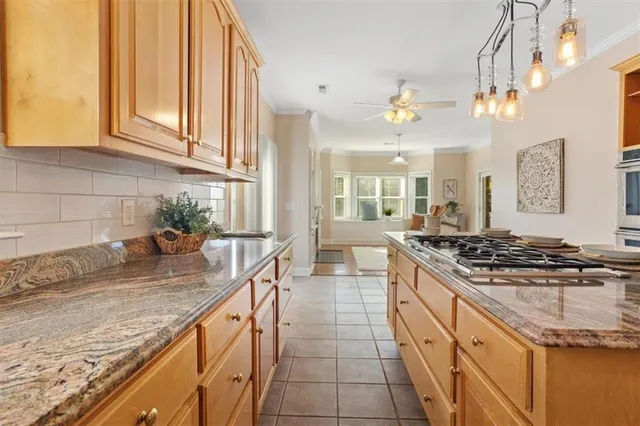 a view of an empty room with wooden floor and a fireplace