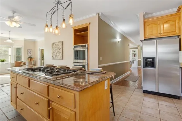 a spacious bathroom with double vanity a a mirror a bathtub and a window