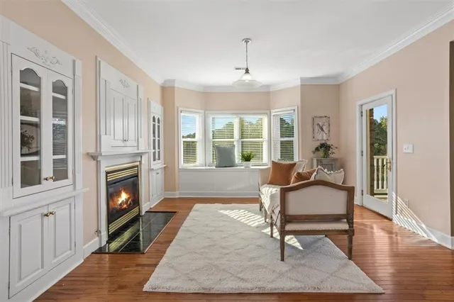 a bathroom with a granite countertop double vanity sink a mirror and a shower