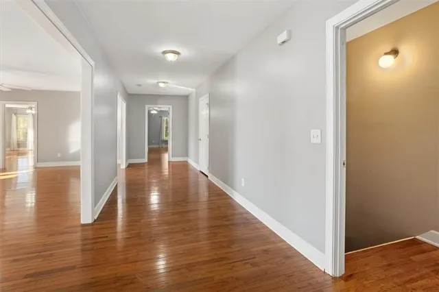 a view of a big house with a big yard and large trees