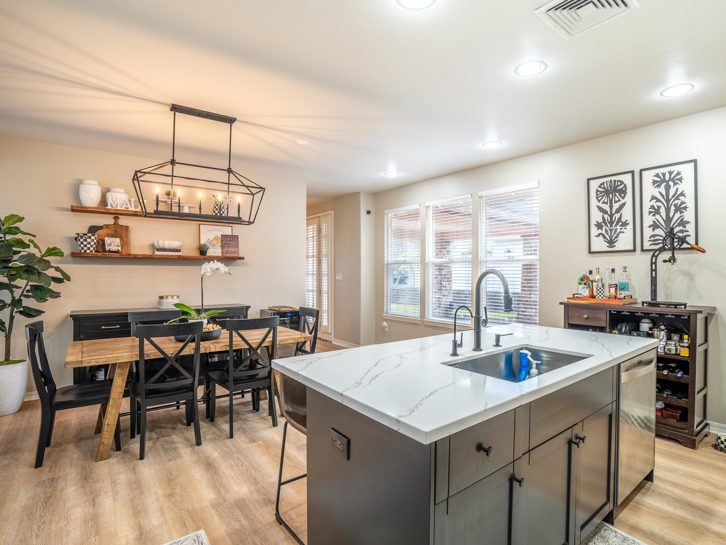 42 Maunaleo Place Wailuku, HI 96793 - Photo 11 of 36 a kitchen with a table chairs and white cabinets