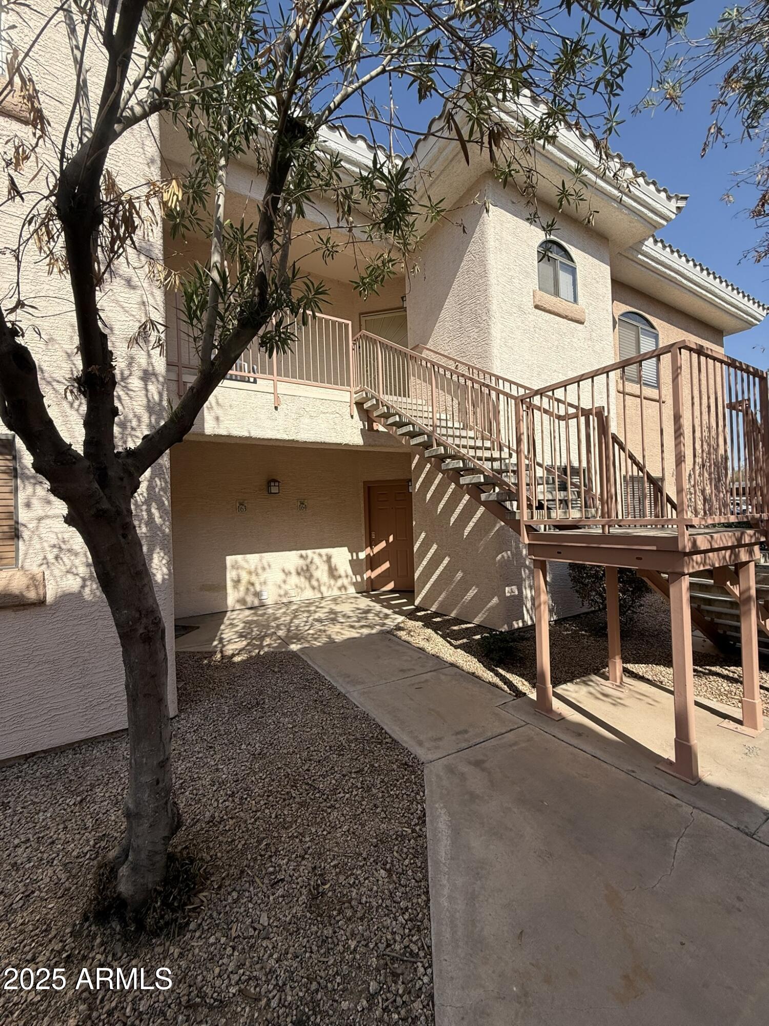 10030 West Indian School Road, Unit 164 Phoenix, AZ 85037 - Photo 4 of 16 a view of a house with a yard