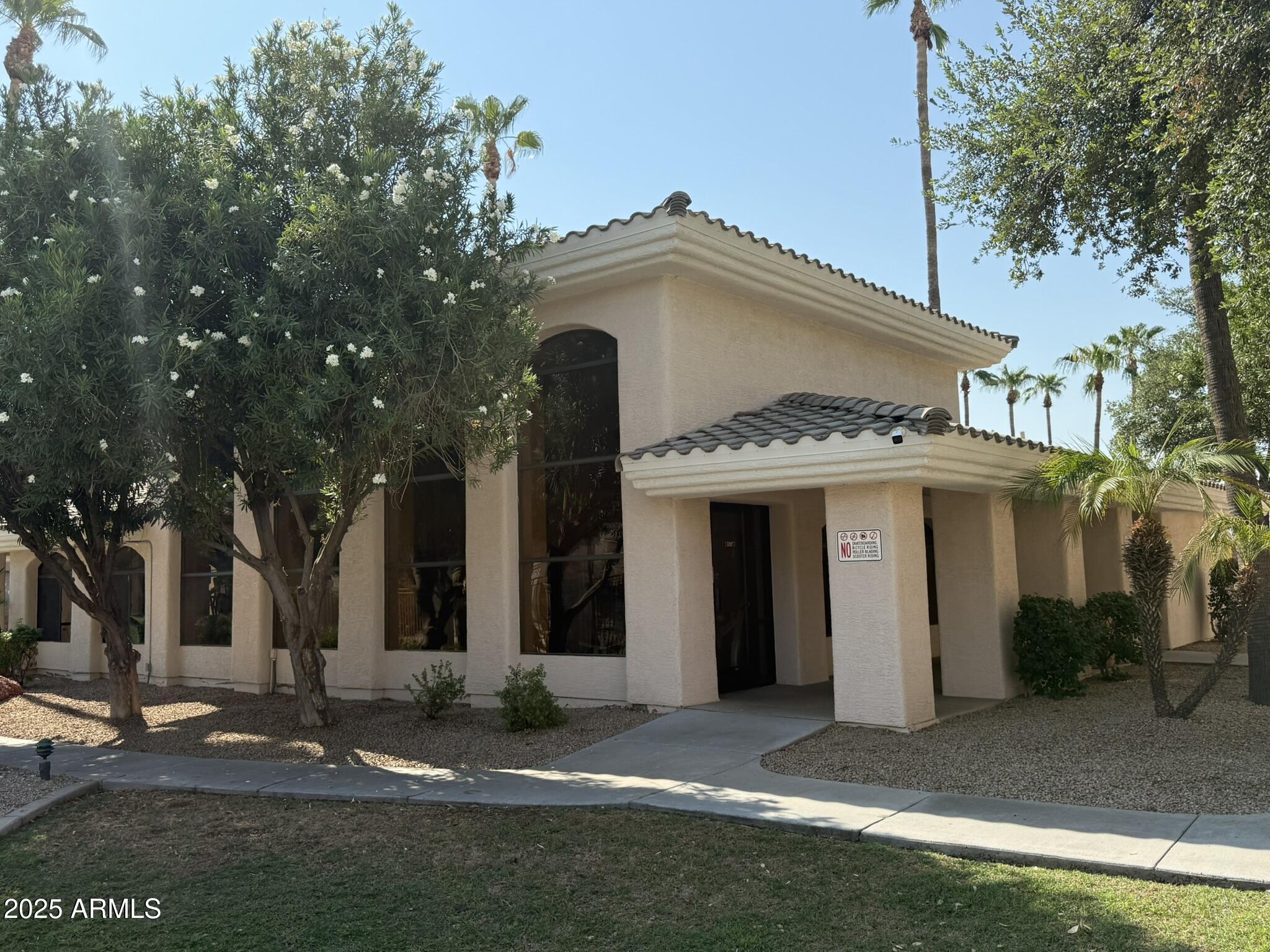 10030 West Indian School Road, Unit 164 Phoenix, AZ 85037 - Photo 9 of 16 a view of a white house with a yard and plants