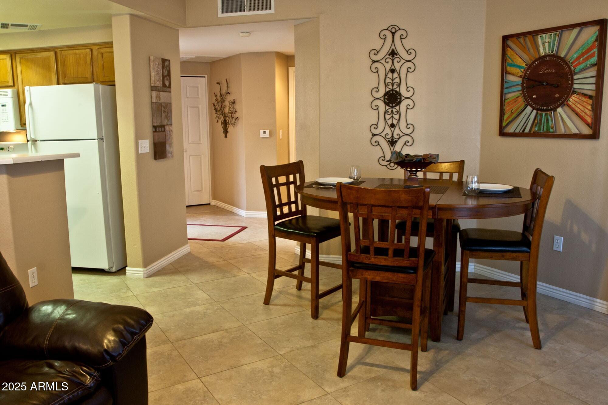 10030 West Indian School Road, Unit 164 Phoenix, AZ 85037 - Photo 10 of 16 a view of a dining room with furniture