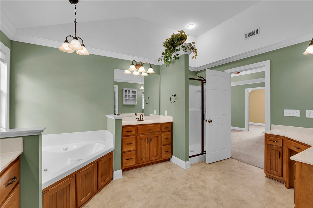 406 Hopewell Ridge Anderson, SC 29621 - Photo 21 of 46 Relax and refresh in this expansive primary bathroom, featuring a corner soaking tub and spacious vanity.