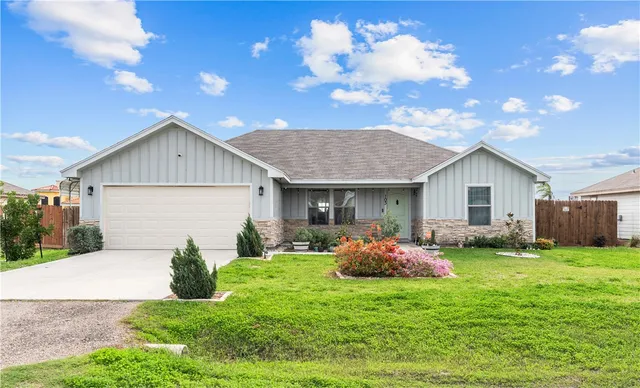 a front view of house with yard and outdoor seating