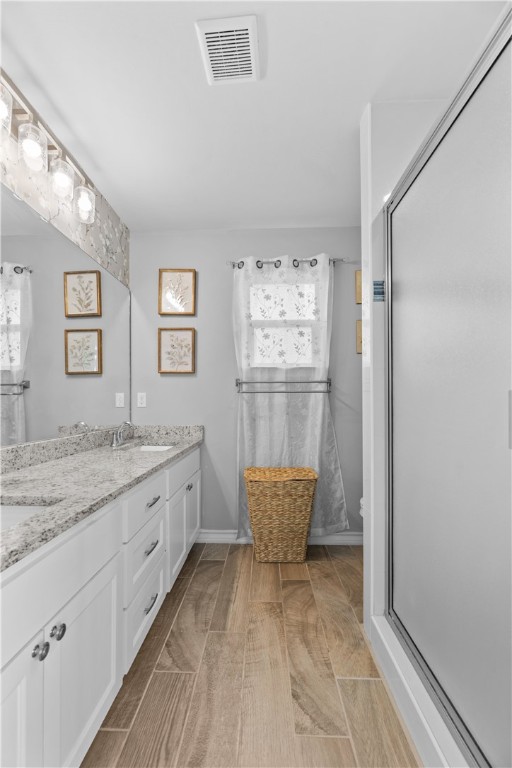 103 Atkinson Drive Orange Grove, TX 78372 - Photo 18 of 30 a bathroom with a granite countertop sink a toilet and shower