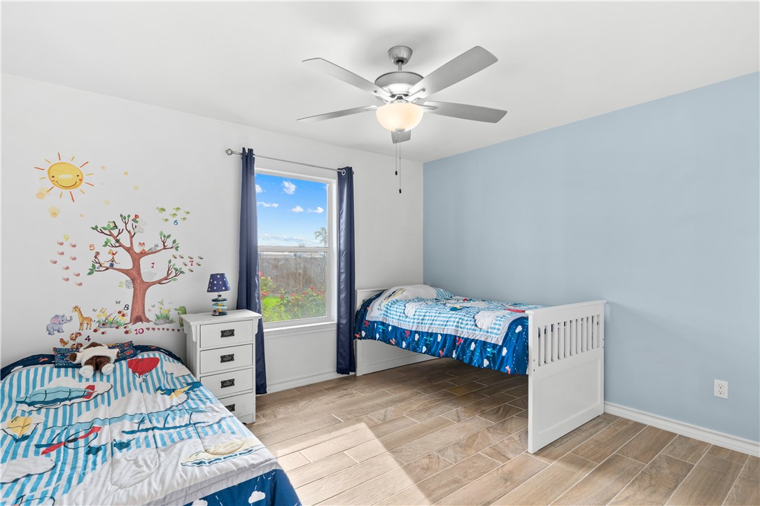 103 Atkinson Drive Orange Grove, TX 78372 - Photo 20 of 30 a bedroom with furniture and a window