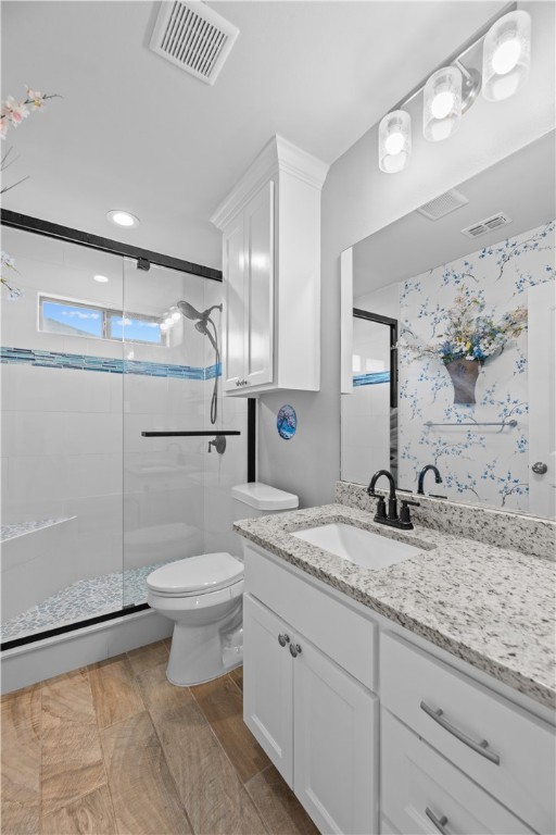103 Atkinson Drive Orange Grove, TX 78372 - Photo 21 of 30 a bathroom with a granite countertop sink a toilet and a shower