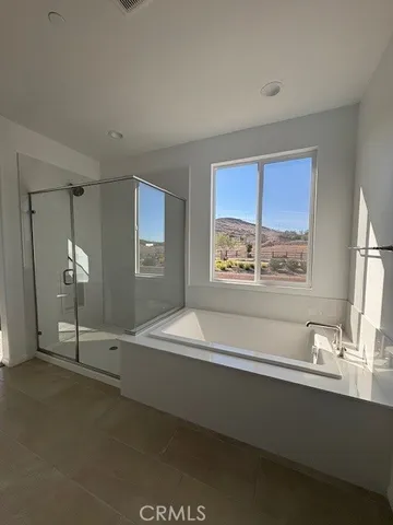 a large white room with a large mirror and a sink