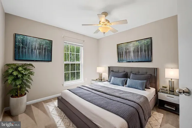 a bedroom with a bed and a painting on the wall