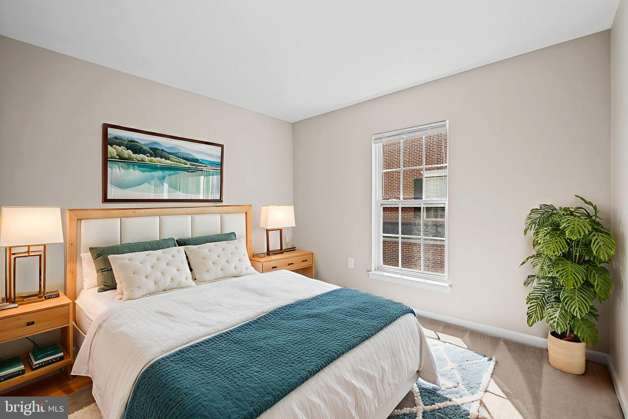 23404 Rainbow Arch Drive, Unit 115 Clarksburg, MD 20871 - Photo 15 of 34 a bedroom with a large bed and a potted plant