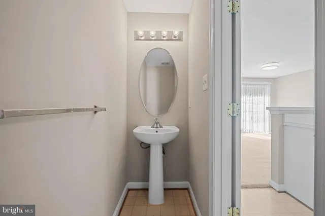 a view of a bathroom with a sink and a mirror