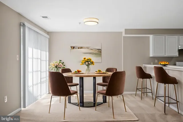 a view of a dining room with furniture and window