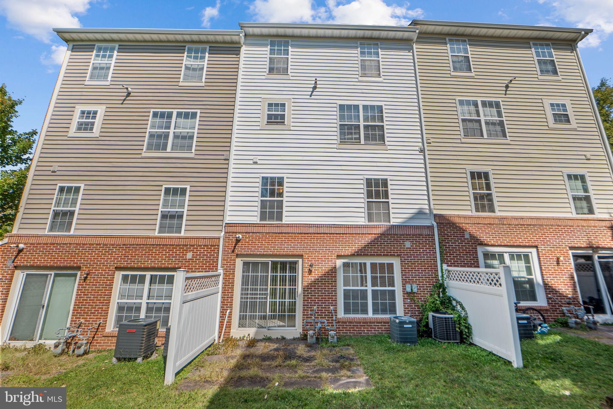 23404 Rainbow Arch Drive, Unit 115 Clarksburg, MD 20871 - Photo 32 of 34 a front view of a house with a yard