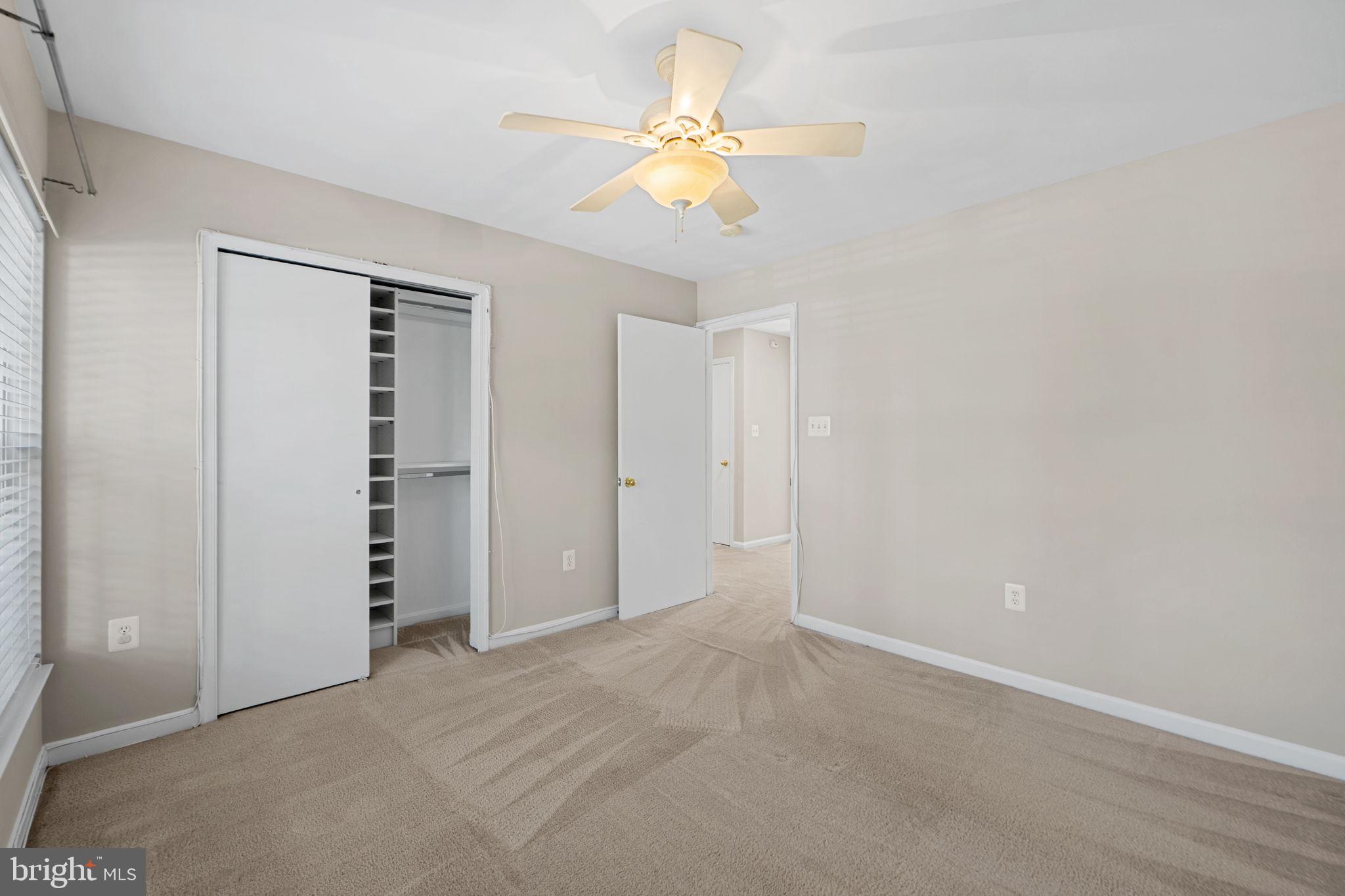23404 Rainbow Arch Drive, Unit 115 Clarksburg, MD 20871 - Photo 9 of 34 an empty room with closet and a ceiling fan