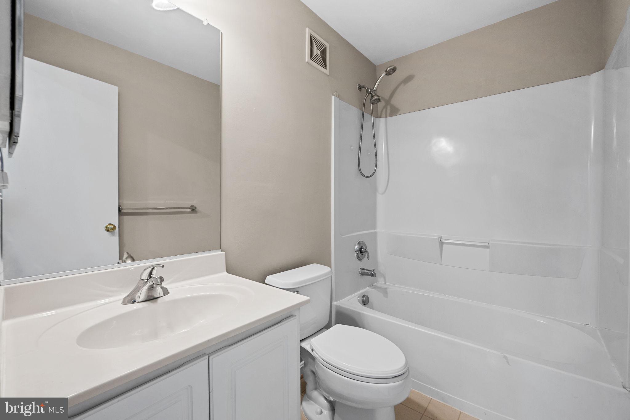 23404 Rainbow Arch Drive, Unit 115 Clarksburg, MD 20871 - Photo 10 of 34 a bathroom with a sink toilet vanity and shower