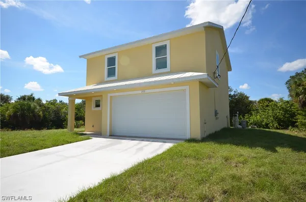 a front view of a house with a yard