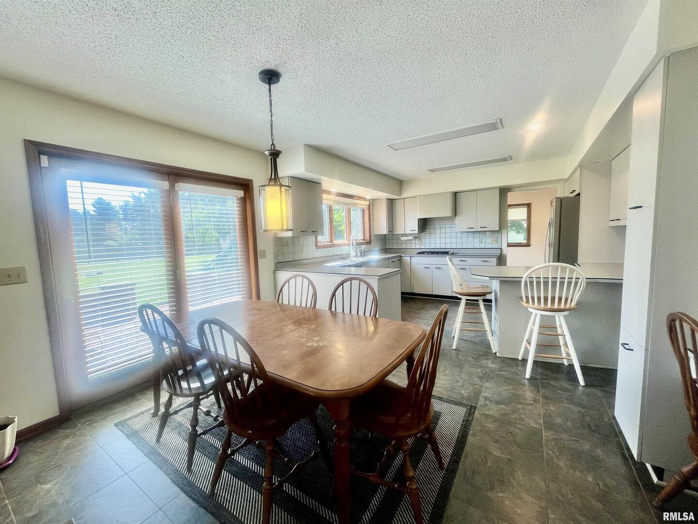 9 Brian Drive Metropolis, IL 62960 - Photo 26 of 71 a dining room with furniture a chandelier and wooden floor