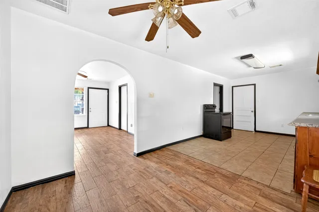 a view of a livingroom with wooden floor and a ceiling fan