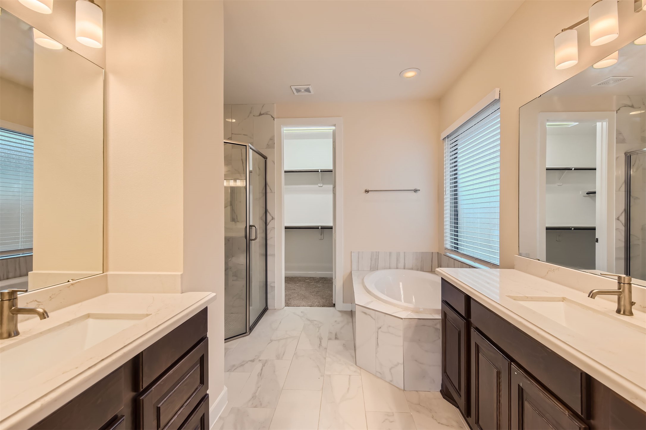 8313 Spire View Austin, TX 78744 - Photo 16 of 33 Luxurious bathroom with dual vanities and a deep soaking tub provides a relaxing retreat.