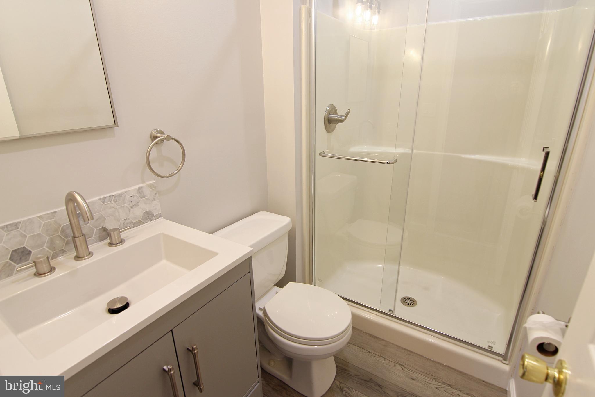 7923-31 Ridge Avenue, Unit 38 Philadelphia, PA 19128 - Photo 11 of 23 a bathroom with a sink toilet and shower