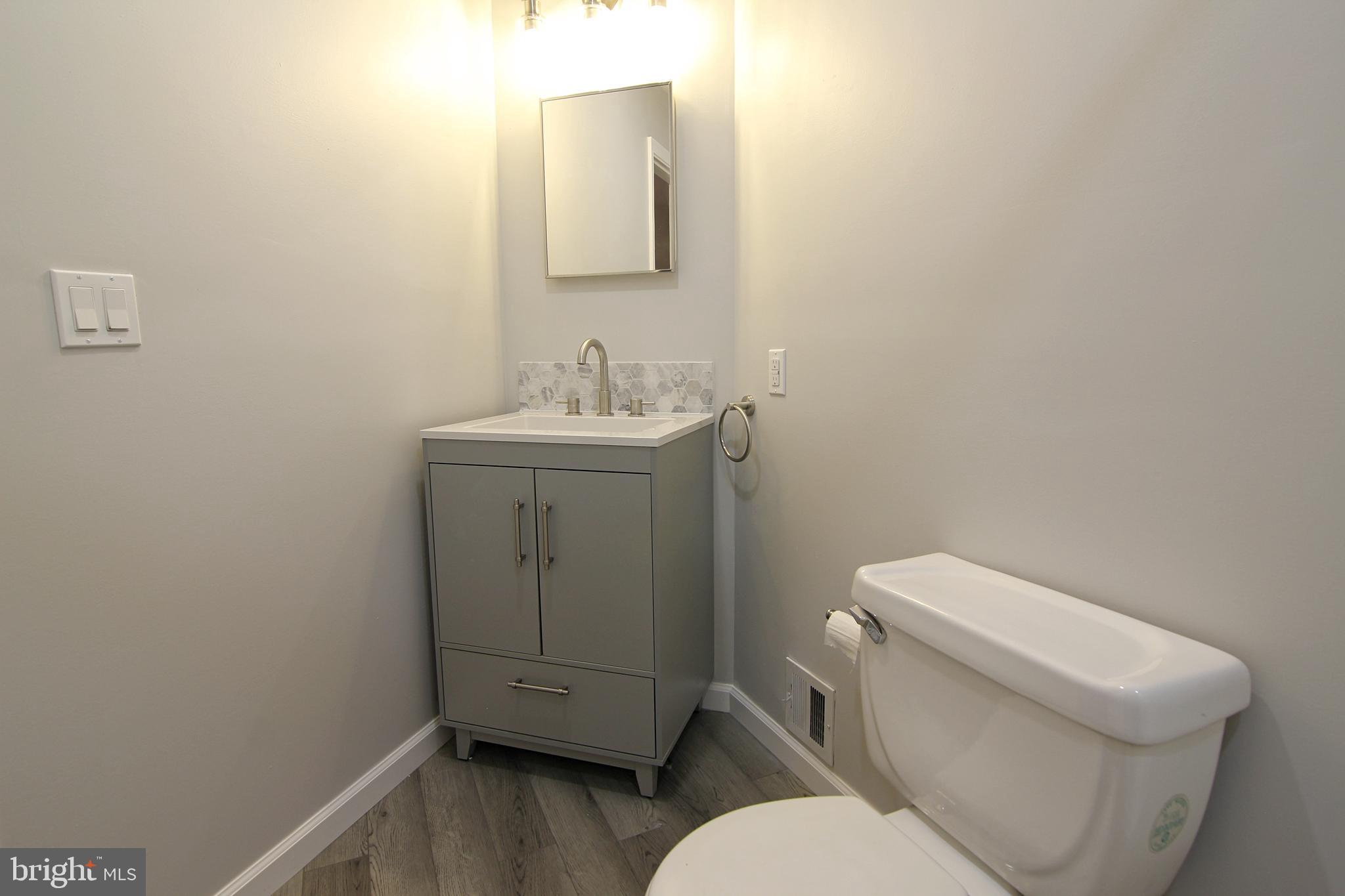 7923-31 Ridge Avenue, Unit 38 Philadelphia, PA 19128 - Photo 14 of 23 a white toilet sitting next to a bathroom sink