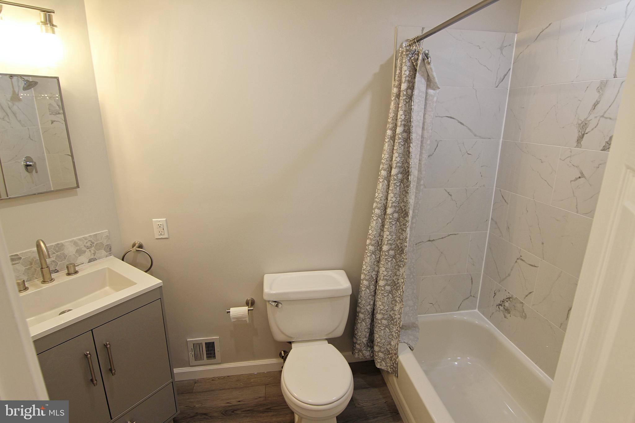 7923-31 Ridge Avenue, Unit 38 Philadelphia, PA 19128 - Photo 15 of 23 a bathroom with a toilet sink and shower