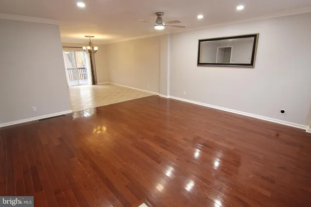 a view of an empty room with wooden floor